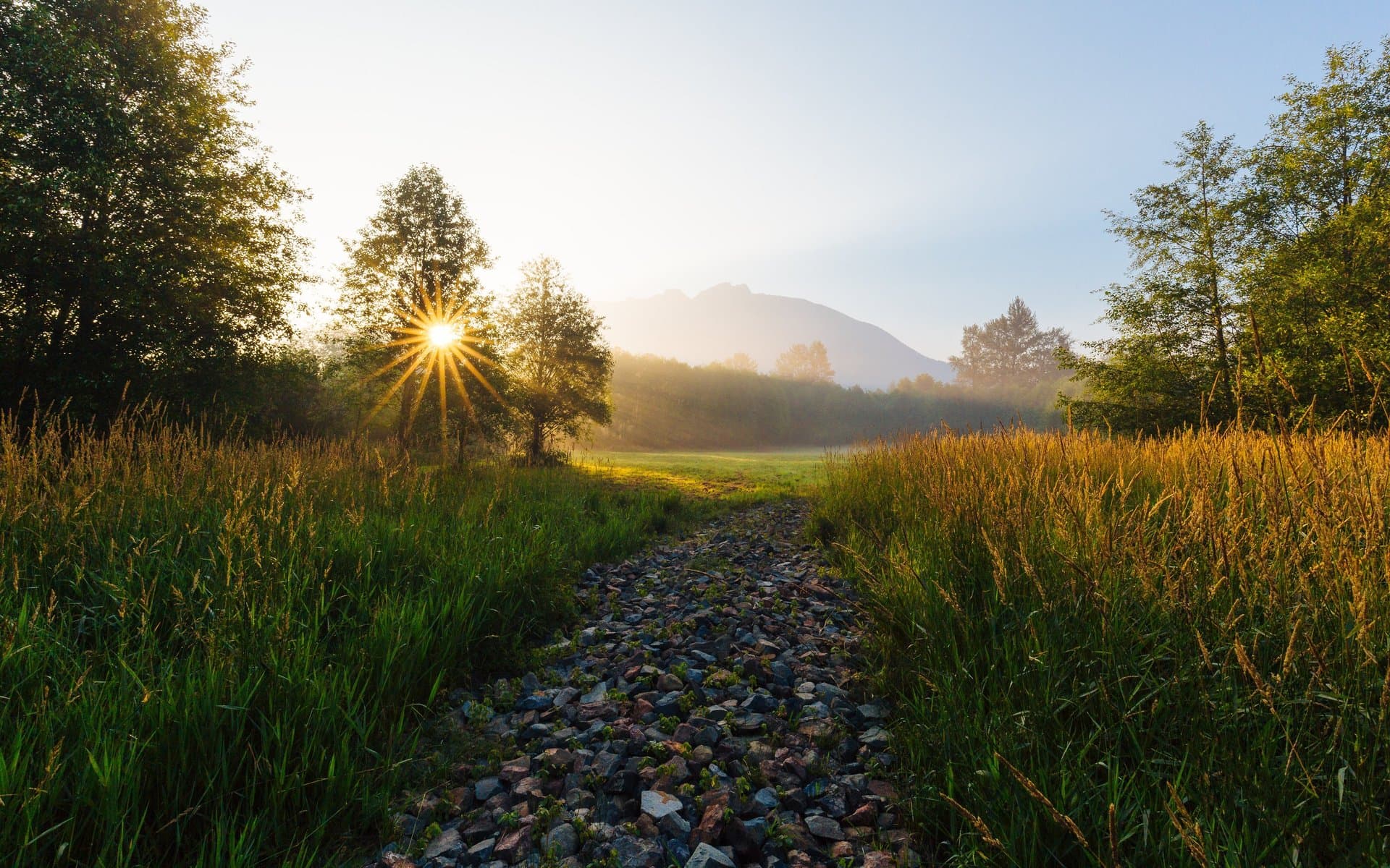 Mountain sunrise over open land